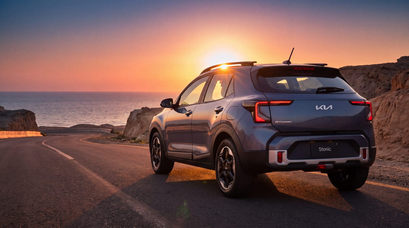Rear view of the Stonic on a coastal road with the sun setting over the sea